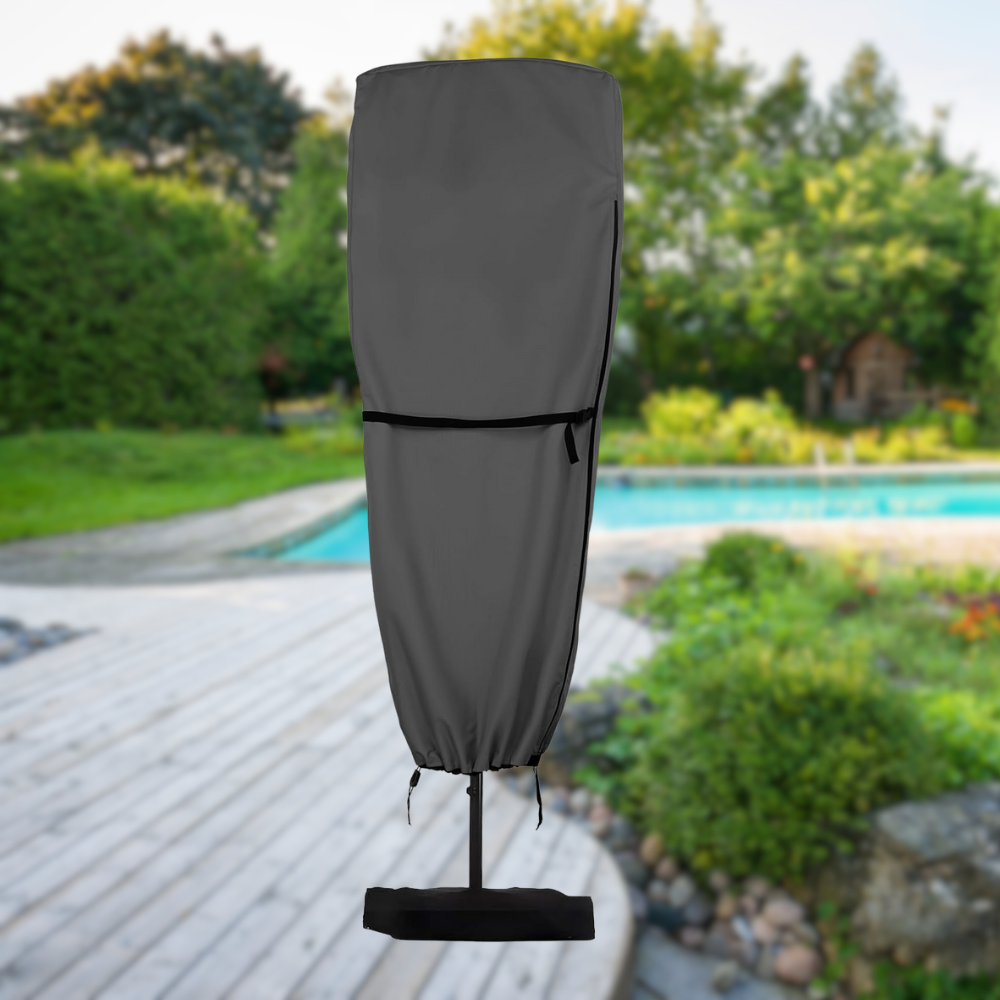 Black patio umbrella cover on a stand outdoors with a pool and garden in the background
