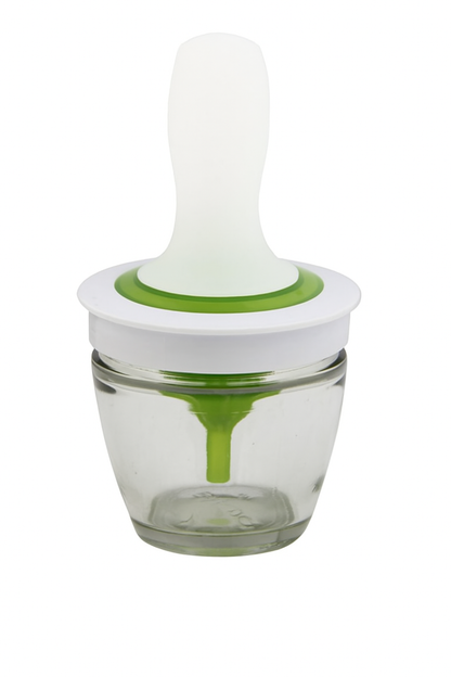 Glass container with a white and green lid on a white background